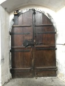 This ancient looking door led us into one of those wine storage passageways.